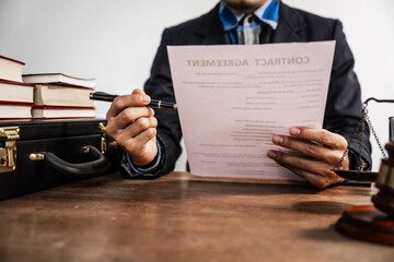 Lawyers meticulously read and check contracts, ensuring legal compliance and protecting clients...
