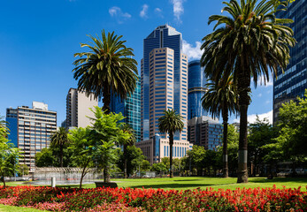 Melbourne, Victoria, Australia – Fountain and palm trees in Melbourne's Parliament Gardens, with the city skyline in the background.