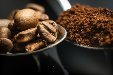 close up of spoon loaded with coffee beans and powder 