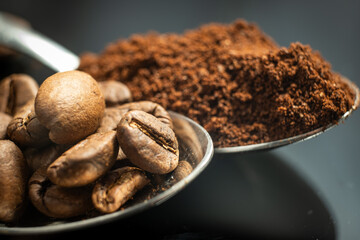 close up of spoon loaded with coffee beans and powder 