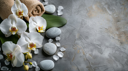 Beautiful orchid composition with spa stones on grey marble table , zen stones on white, a white candle, flowers and stones. spa concept. relaxation