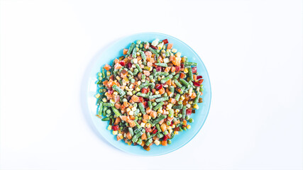 A mixture of frozen vegetables prepared for food. The concept of cooking quick-frozen foods.