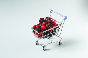 A mixture of frozen berries in a grocery basket in close-up.