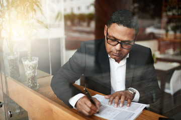 Businessman, corporate paperwork and writing in cafe for lawyer contract, legal document and glasses. Paralegal, person and review for insurance claim, investment policy and remote work by window - obrazy, fototapety, plakaty