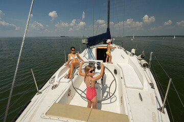 woman on a yacht, a girl holding on to the ropes of a yacht, a girl holding the helm of a yacht,...
