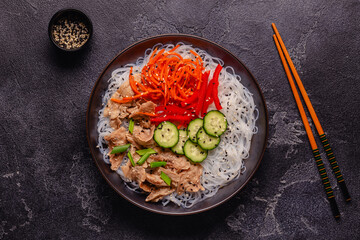 Bowl of rice noodles with vegan soy meat and vegetables. - 783767213