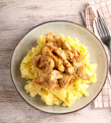 Turkey fillet with mushrooms in creamy sauce over mashed potatoes