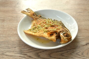 crispy fried white butterfish or silver pomfret arranging dressing Thai spicy seafood chili on plate 