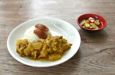 spicy bailed winter melon with pork curry soup eat couple rice on plate dipping  sweet chili syrup sauce 