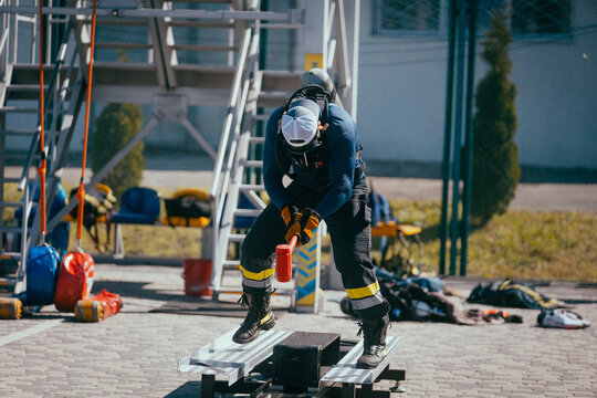 Firefighter training. Firefighters training on the sports ground.