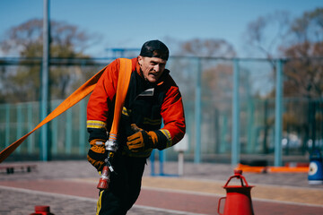 Firefighter training. Firefighters training on the sports ground.