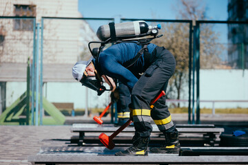 Firefighter training. Firefighters training on the sports ground.