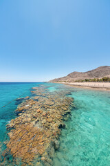 Underwater corals along empty beach on popular resort of Eilat on Red Sea in Israel.	