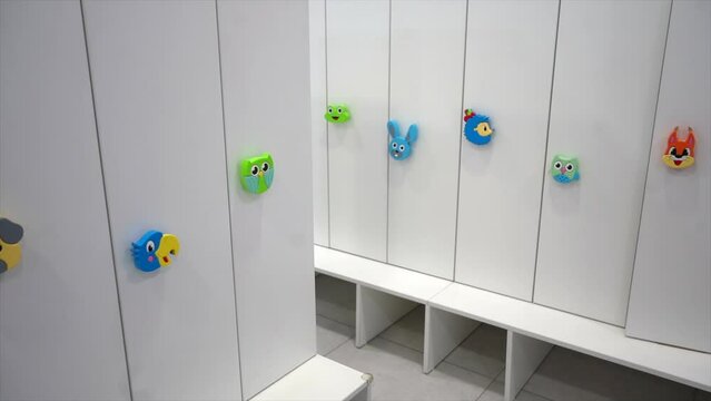 Cartoon Animal Hooks on White Lockers in a Child-Friendly Space