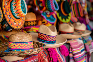 Colorful Mexican handbags and hats for sale at an outdoor market in Todosco, Mexico