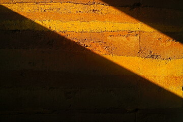 sunlight on the rammed earth wall 
