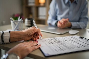 Two mature woman signature document, contract at work at office