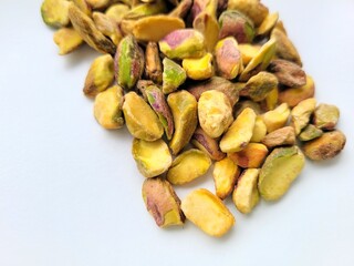Yummy pile of pistachios on bright background.