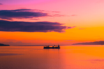 Fototapeta na wymiar Sunset and ship silhouettes in Ambon Bay, Indonesia