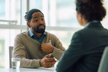 African American man talking to his financial advisor on meeting in office.