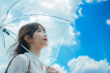 梅雨の晴れ間、雨があがった青空を見上げる通勤中の若いol・会社員・日本人女性(美人モデル)