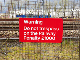 Trespass warning sign and penalty notice at railway