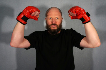 Boxer in red boxing gloves. Athlete, bodybuilder, athlete, muscle, sport, mma, fight, danger.                            Pugilist, mauler, pug, sparrer, prize-fighter