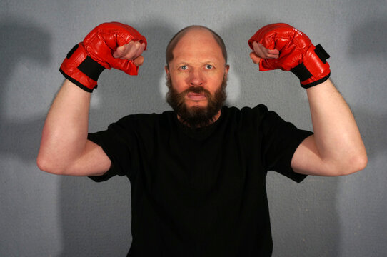 Boxer in red boxing gloves. Athlete, bodybuilder, athlete, muscle, sport, mma, fight, danger.                            Pugilist, mauler, pug, sparrer, prize-fighter