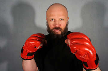Boxer in red boxing gloves. Athlete, bodybuilder, athlete, muscle, sport, mma, fight, danger.                            Pugilist, mauler, pug, sparrer, prize-fighter