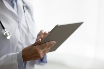 Close up woman therapist using tablet at workplace, lead communication with patient remotely,...