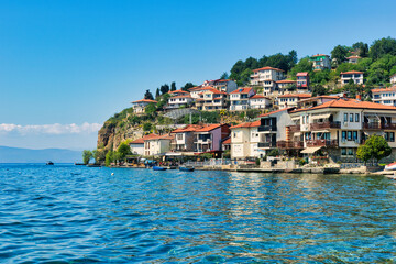 Lake Ohrid, North Macedonia, April 13 2024. Mountain range and peninsula in distance. Ohrid Lake, Macedonia, Europe. The clear mesmerizing waters of lake Ohrid with a beautiful view.   - obrazy, fototapety, plakaty