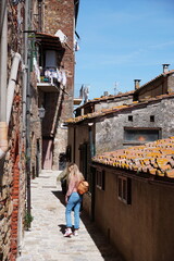 Naklejka premium Chiusdino, Siena, Tuscany, Italy - Typical tuscan historical town with narrow street and terracotta bricks.