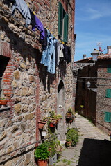 Obraz premium Chiusdino, Siena, Tuscany, Italy - Typical tuscan historical town with narrow street and terracotta bricks.