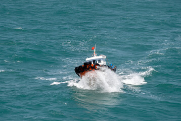 The Asian boat of the pilot in the high sea during a storm.