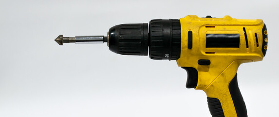Old screwdriver with drill bit on white background.