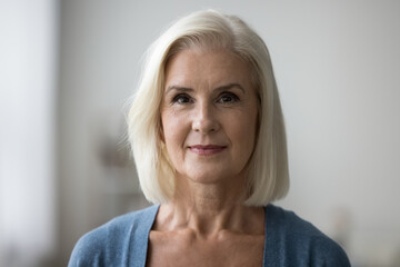 Head shot profile picture of mature Caucasian woman having attractive appearance posing alone...