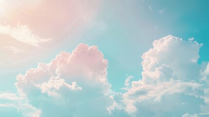 A beautiful display of fluffy white clouds drifting across a soft blue sky, illuminated by gentle sunlight - obrazy, fototapety, plakaty