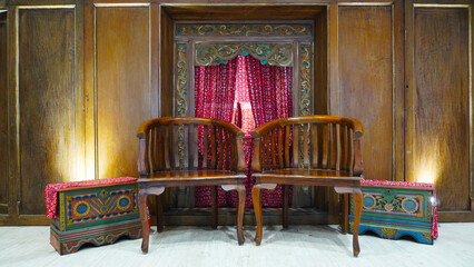 vintage heritage interior of Javanese Indonesian culture. decoration wooden chair in front of the door