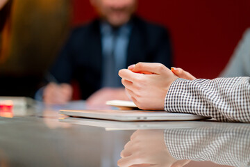 close up hands In conference red walls office workers are sitting at the head of the director...