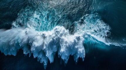 This aerial photo captures the immense power and beauty of a crashing ocean wave - obrazy, fototapety, plakaty