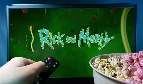 A viewer watches the series Rick and Morty with a remote control in his hand and popcorn. Stock illustrative editorial photo. Ukraine. Kyiv. 04.05.2024