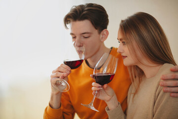 Young couple drinking wine at home