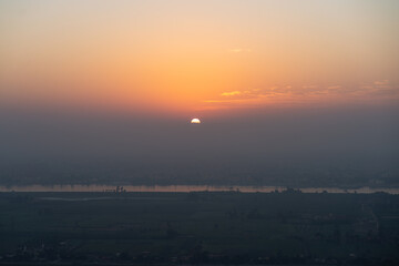 Luxor, Egypt - October 27, 2022. Sunrise over the NIle river from the balloon near Luxor. - 783867404