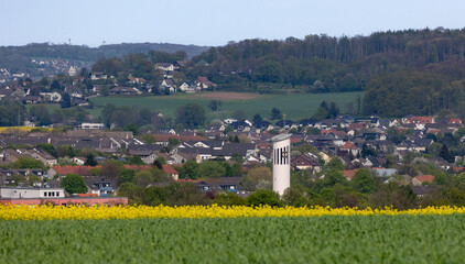 Blooming rapeseed field with a view of Menden sauerland (Platte Heide)