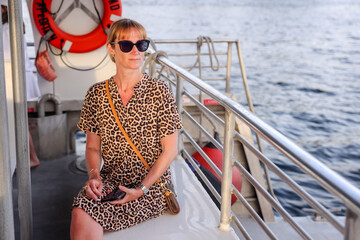 Fort Lauderdale, Florida - March 23, 2024: A fashionable woman taking in the sights froma boat along the canals of Fort Lauderdale, Florida
