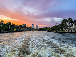 Fort Lauderdale, Florida - March 23, 2024: Mansions and luxury yachts at sunset along the canals of Fort Lauderdale, Florida
