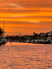 Fort Lauderdale, Florida - March 23, 2024: Mansions and luxury yachts at sunset along the canals of Fort Lauderdale, Florida
