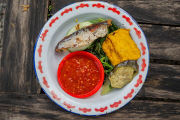 Traditional food of Javanese chicken, tofu, tempe and chili sauce. The photo is suitable to use for traditional food background and snack content media
