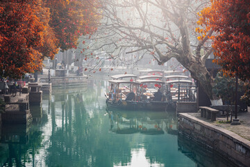 Wooden retro boats stand along the houses in ancient china town. - 783883239