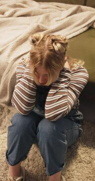 Depression, stress and sad woman in a floor with anxiety, disaster or mental health crisis at home. Top view, paranoid and female person in a living room overthinking mistake, fail or trauma memory